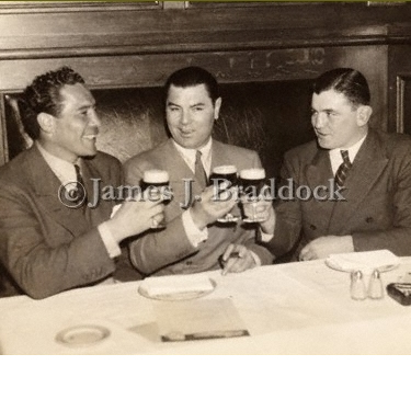 Max Baer, Jack Dempsey and Jim Braddock toast each other at Dempsey's restaurant in NYC, 1935
