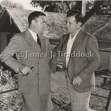 Abe Greene, boxing commissioner of New Jersey, and Jim Braddock at Joe Louis' training camp while Louis trains for the Tommy Farr fight. Pompton Lakes, NJ. 8/4/1937.
